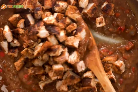 Step-04-Add-re-fried-beans-diced-chicken-and-water.-Cook-for-2-minutes